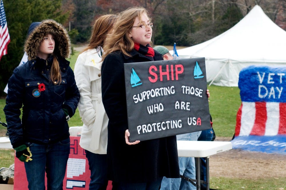 James Madison freshman Emma Chanlder displays SHIP's sign highlighting what the organization does on Friday at The Rock. SHIP was raising money to send packages to military members in other countries. Anthony Thibodeau/The State News