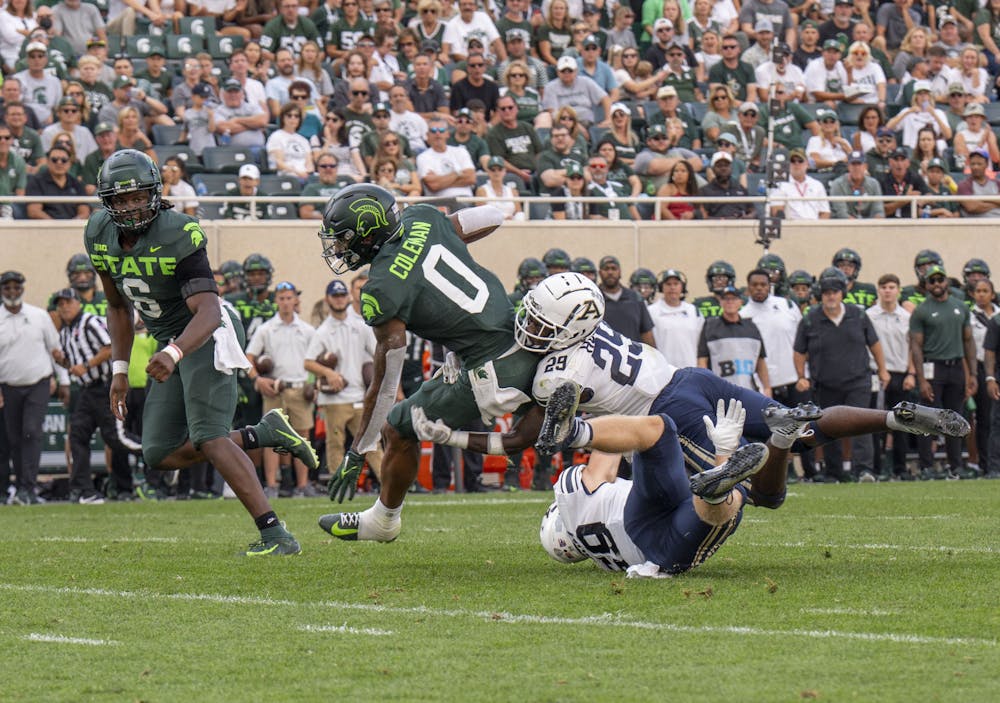 <p>Sophomore wide receiver Keon Coleman, 0, attempts to evade a tackle during Michigan State’s game against Akron on Sat., Sept. 10, 2022 at Spartan Stadium. The Spartans earned a decisive victory with a final score of 52, zip. </p>