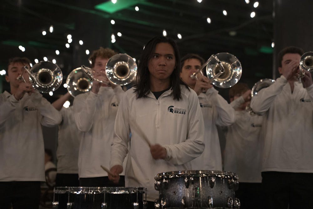 Draven Tanafranca, a senior in the Spartan Brass, plays the drums at a Michigan State men's basketball watch party in Atlanta on March 28, 2025.