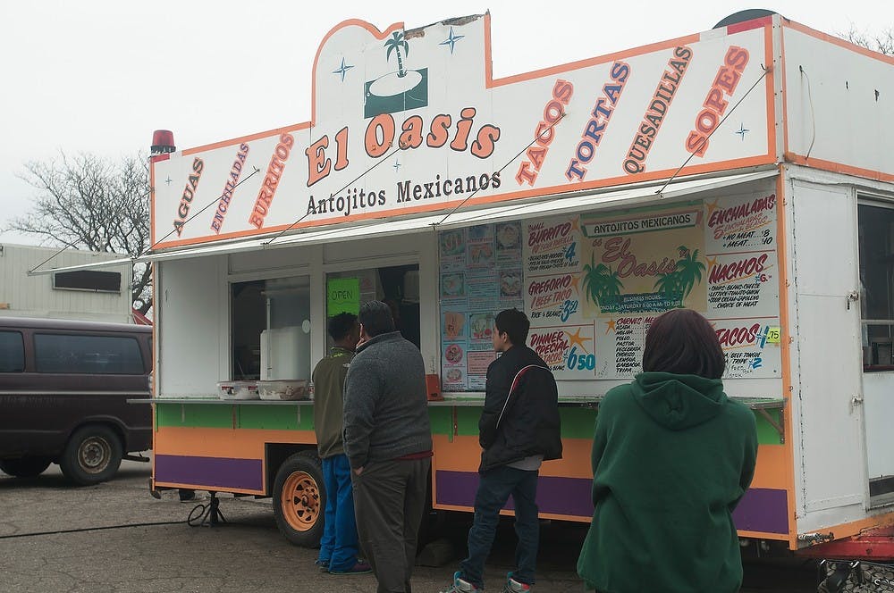 <p>Customers wait to order food April 16, 2015, at El Oasis Food Truck in Lansing. Kennedy Thatch/The State News</p>