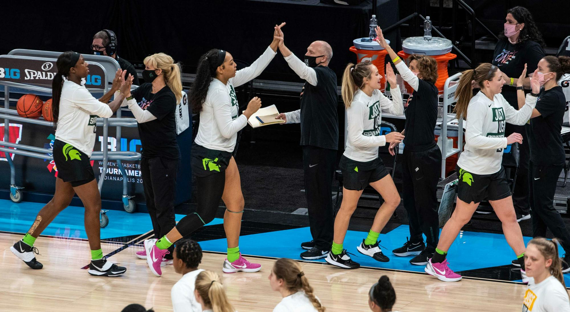 <p>Head Coach Suzy Merchant, along with the rest of the coaching staff, high five the team as they prepare for their game against Iowa. The Spartans fell to the Hawkeyes, 87-72, in the semifinals of the Big Ten Tournament on March 12, 2021. </p>