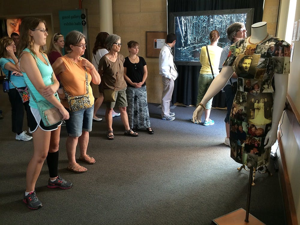 <p>People look at "The Living History Project: Stories Told by Michigan's Oldest Old" during the first week of ArtPrize at DeVos Place Convention Center in Grand Rapids. Photo courtesy of Bob Gould</p>