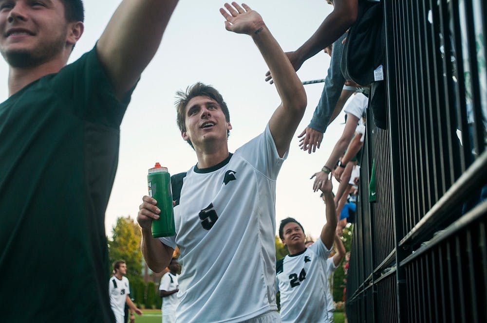 	<p>Senior defender Ryan Thelen high fives the Red Cedar Rowdies at the end of the game against Bowling Green on Sept. 18, 2013, at DeMartin Stadium at Old College Field. The Spartans defeated the Falcons, 1-0. Danyelle Morrow/The State News</p>
