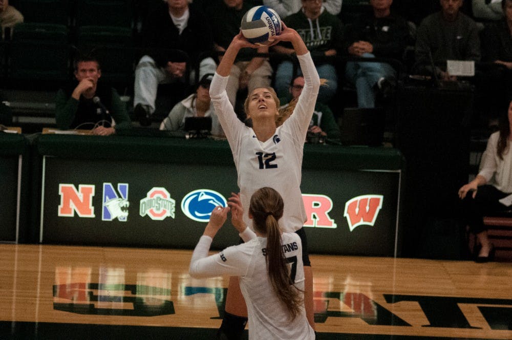 Junior setter Rachel MInarick (12) sets the ball during the game against Maryland on Oct. 8, 2016 at Jenison Field House.  The Spartans defeated the Terrapins, 3-1. 