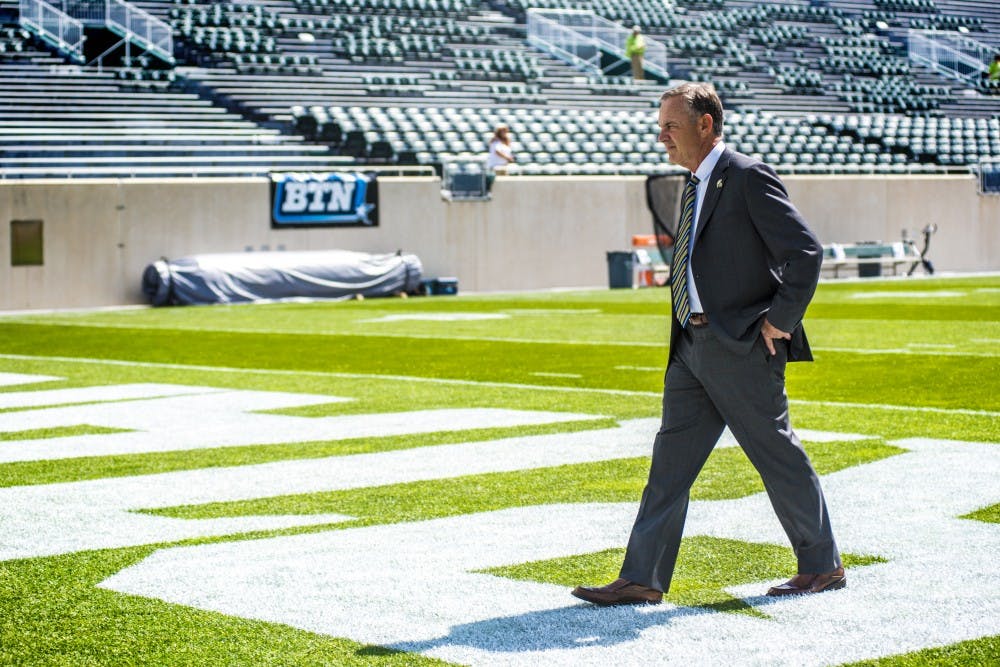 Head coach Mark Dantonio walks the field before the game against Western Michigan on Sept. 9, 2017 at Spartan Stadium. Michigan State running back L.J. Scott (3)