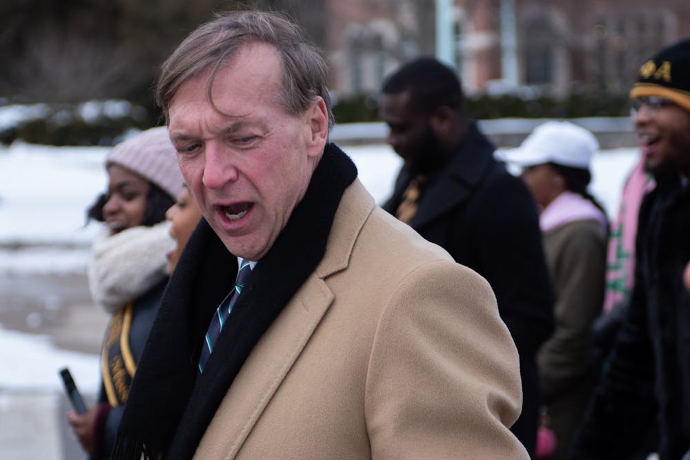 MSU President Samuel L. Stanley Jr. chants during the MLK march on MSU's campus on January 20, 2020. 
