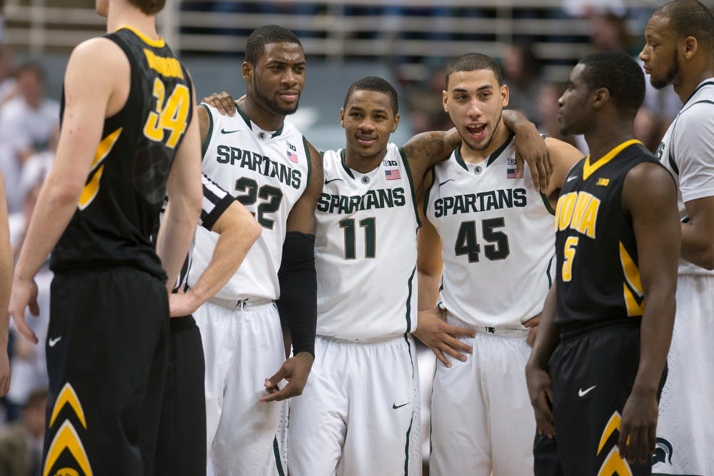 <p>From left to right, junior guard/forward Branden Dawson, senior guard Keith Appling and sophomore guard Denzel Valentine stand together March 6, 2014, at Breslin Center during the game against Iowa. The Spartans defeated the Hawkeyes, 86-76. Julia Nagy/The State News</p>