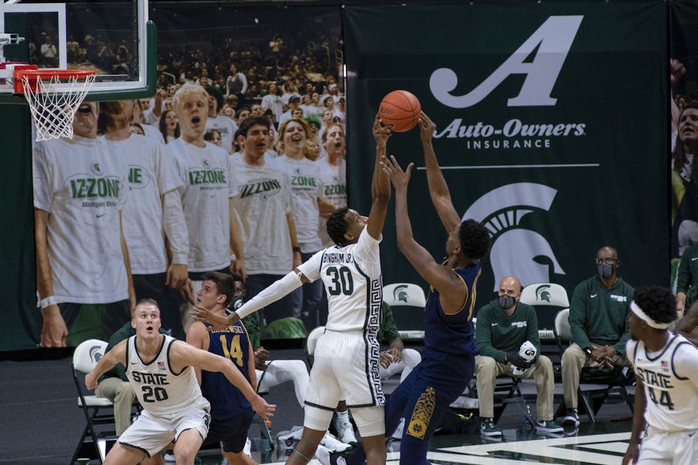 <p>Junior forward Marcus Bingham Jr. (30) blocks an attempt on the net by Notre Dame&#x27;s forward Juwan Durham (11). Michigan State triumphed over Notre Dame, 80-70, on Nov. 28, 2020. </p>