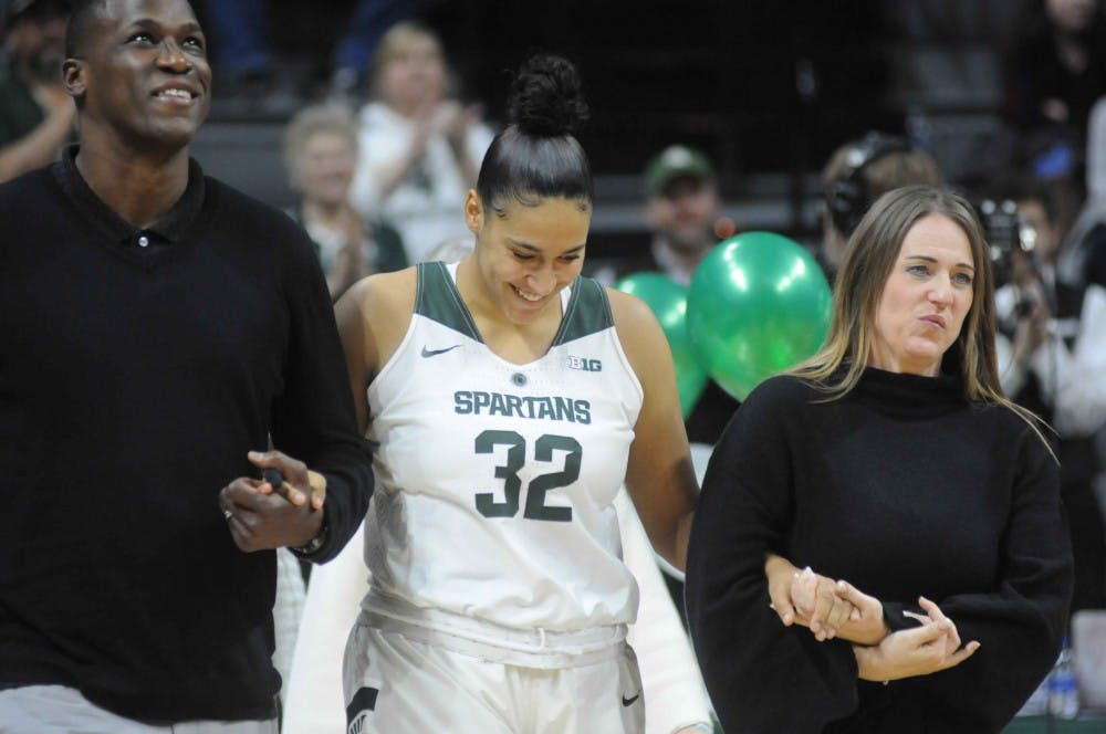 Senior forward Taya Reimer (32) walks with her family after the women's basketball game against Wisconsin on Feb. 21, 2018 at Breslin Center. The Spartans defeated the Badgers, 69-61. (Annie Barker | The State News)