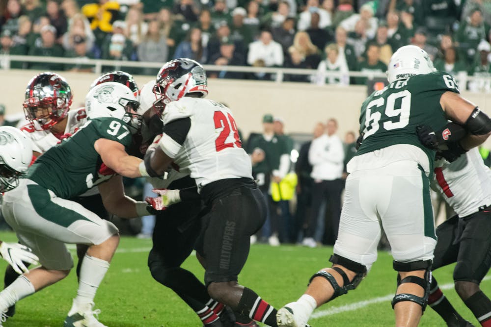 <p>Then-redshirt junior tight-end Tyler Hunt (97) and then-junior center Nick Samac (59) block the opponent from Western Kentucky during the homecoming game on Oct. 2, 2021. </p>