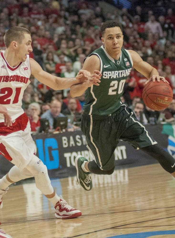 <p>Senior guard Travis Trice dribbles towards the basket Mar. 15, 2015, during the championship game of the Big Ten Tournament against Wisconsin at United Center in Chicago. The Badgers defeated the Spartans in overtime, 80-69. Kelsey Feldpausch/The State News</p>