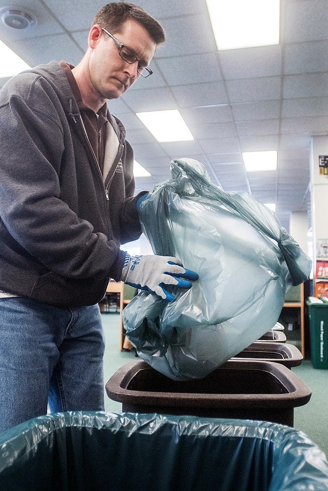 	<p>David Smith, waste reduction coordinator for <span class="caps">MSU</span>, empties garbage bins Tuesday, Feb. 5, 2013, at the <span class="caps">MSU</span> Main Library. <span class="caps">MSU</span> recently was named one of Enviance’s “Sustainable 16,” part of the Second Annual Environmental March Madness tournament, which highlights university efforts to become a more sustainable campus. State News File Photo</p>