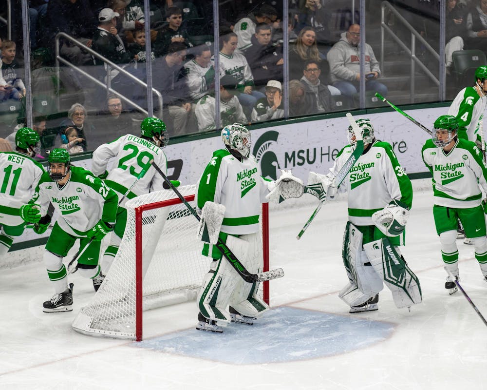 The MSU hockey team skates around their Jr. G, Trey Augustine (1), before their match in Munn Ice Arena in East Lansing, MI on Feb. 19, 2026.