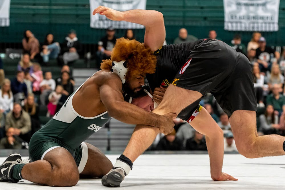 <p>Sophomore Cam Caffey takes down Maryland’s Kyle Jasenski. Caffey defeated Jasenski by pinfall. The Spartans defeated the Terrapins, 36-0, on Jan. 19, 2020 at Jenison Field House.</p>