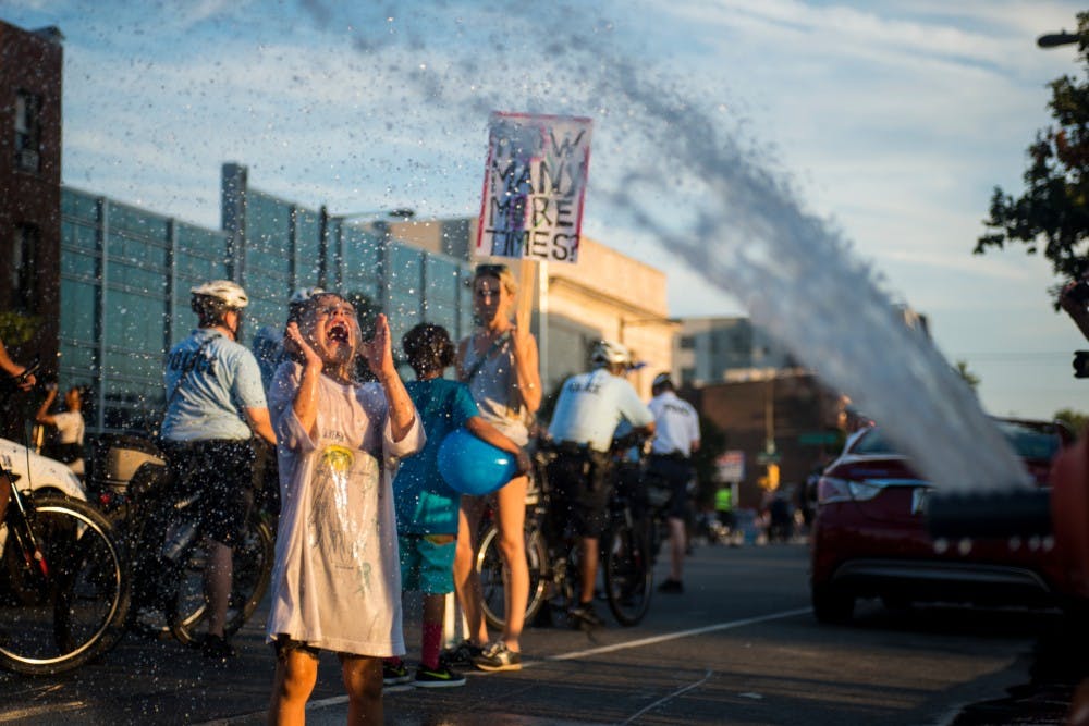 Philadelphia resident Bronson Ramon Weinkrantz, 4, plays in the water spraying from a fire hydrant on July 26, 2016, the second day of the Democratic National Convention, in Philadelphia.