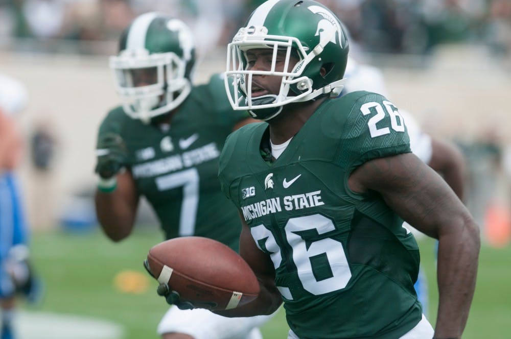 <p>Senior safety RJ Williamson, 26, runs in for a touchdown in the first quarter during a game against Air Force on Sept. 19, 2015, at Spartan Stadium. Williamson scored on a 64-yard fumble return. The Spartans defeated the Falcons, 35-21. Joshua Abraham/The State News</p>