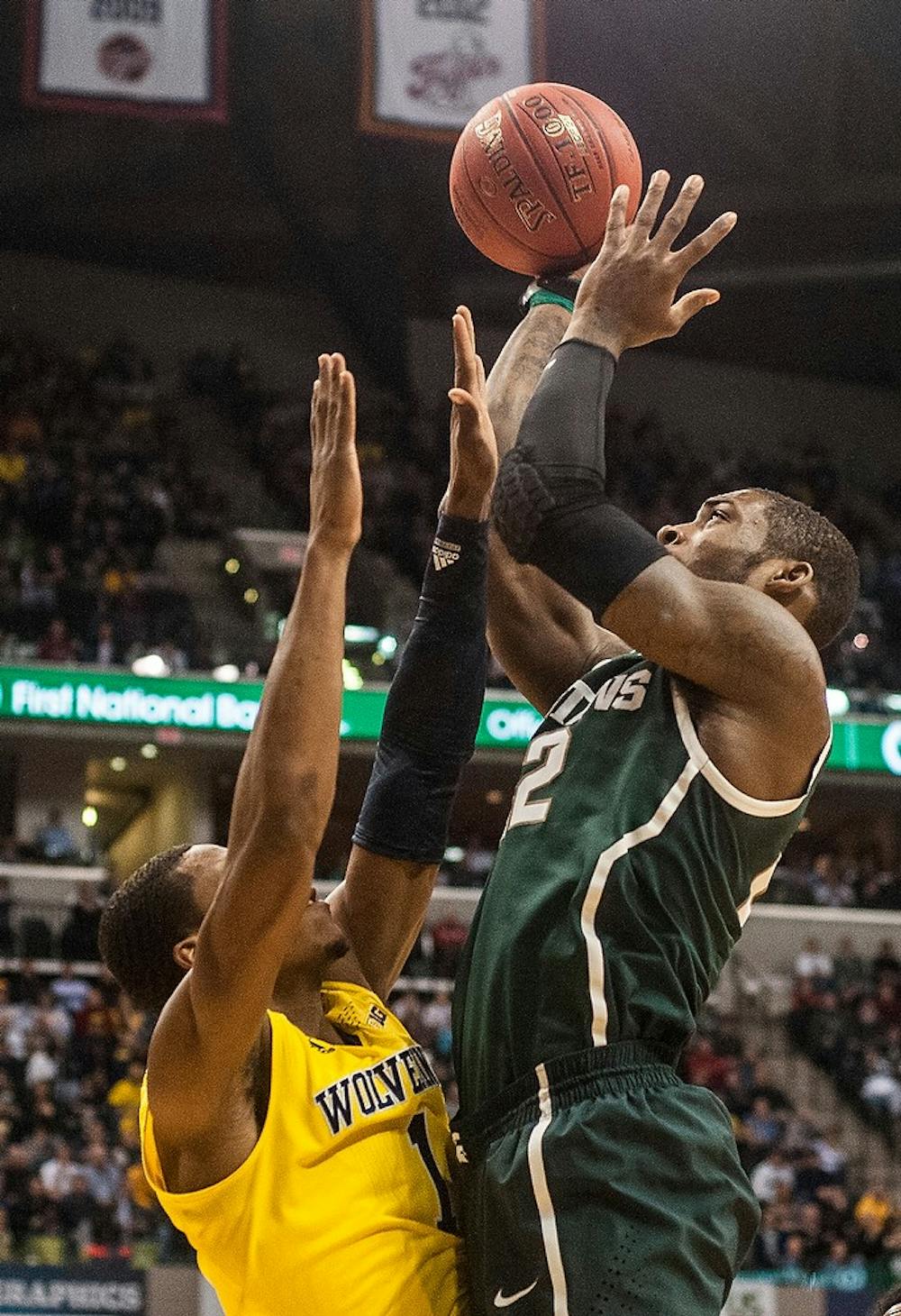 <p>Junior forward Branden Dawson attempts a point over Michigan forward Glenn Robinson III  March 16, 2014, during a game against Michigan at the Big 10 Championship at Bankers Life Fieldhouse in Indianapolis. The Spartans were beating the Wolverines at halftime, 38-29. Erin Hampton/The State News</p>