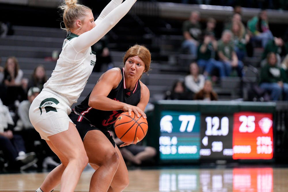 <p>Davenport University redshirt senior guard Mary Liedel (32) attempts to escape Spartan defense during the season-opening exhibition game against Davenport University at the Breslin Center on Nov. 2, 2023. The Spartans annihilated the Panthers with a score of 99-45.</p>