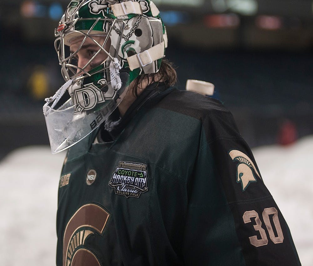 <p>Junior goaltender Jake Hildebrand heads to the locker room Feb. 7, 2015, during the game against Michigan at Soldier Field in Chicago, Illinois.  The Spartans were defeated by the Wolverines, 4-1, during the Coyote Logistics Hockey City Classic. Alice Kole/The State News</p>