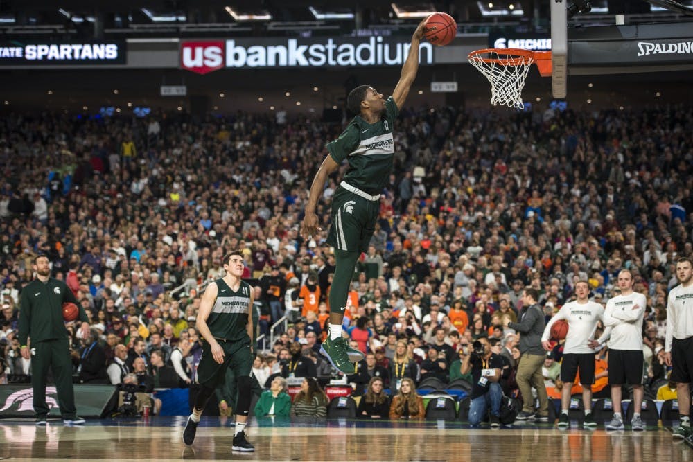 Freshman forward Aaron Henry (11) dunks the ball during Michigan State's NCAA Men's Basketball Final Four open practice at U.S. Bank Stadium in Minneapolis on April 5, 2019. (Nic Antaya/The State News)
