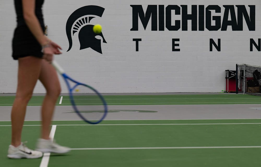 Madeleine Rexroat, a sophomore, walks to retrieve the ball near the net during a singles match at the MSU Tennis Center on Friday, Feb. 6, 2026, in East Lansing