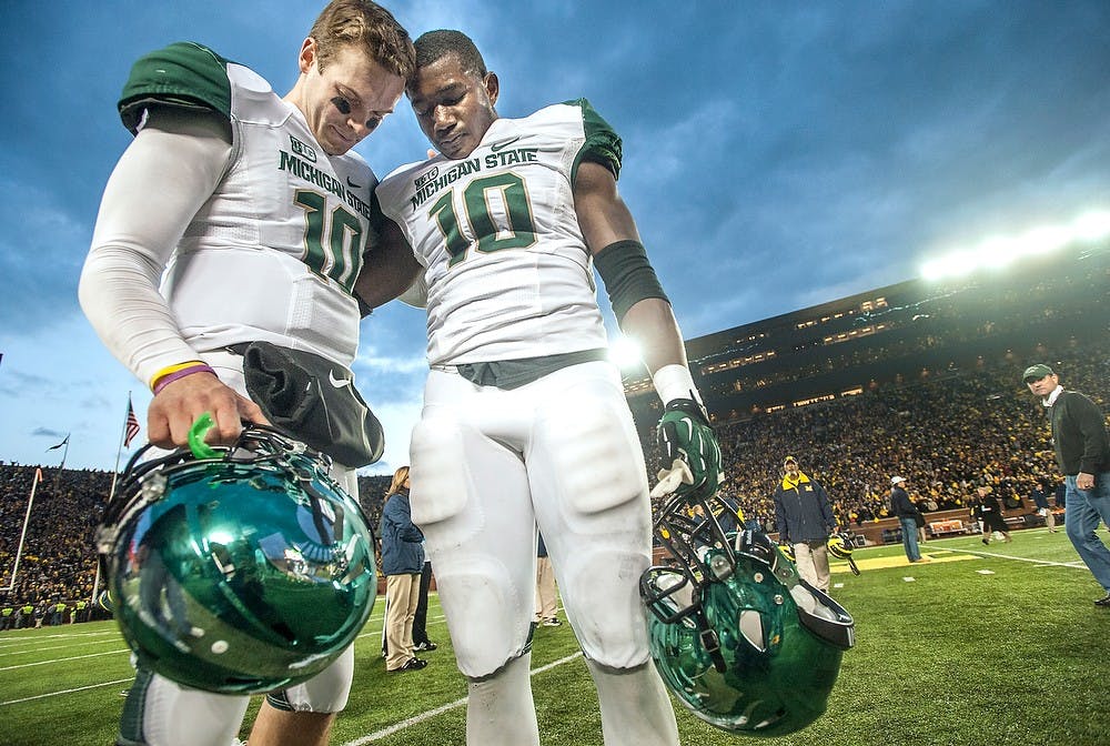 Junior quarterback Andrew Maxwell, left, prays with senior linebacker Chris Norman at the end of the game. Michigan defeated Michigan State, 12-10, on Saturday afternoon, Oct. 20, 2012 at Michigan Stadium in Ann Arbor, Mich. Justin Wan/The State News