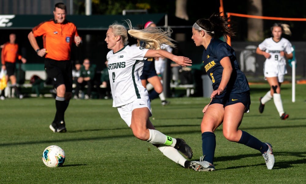 <p>Then-senior midfielder Brooke Cilley (6) tripped then-senior defensive midfielder Michaela Kovacs (4).The Wolverines defeated the Spartans at DeMartin Soccer Stadium, 3-2, on Oct. 19, 2019. </p>