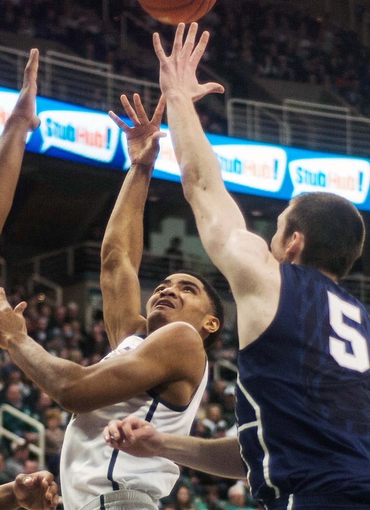 	<p>Sophomore guard Garry Harris reaches for the ball against Penn State  forward Donovon Jack on Feb. 6, 2014, at Breslin Center. The Spartans defeated the Nittany Lions, 82-67. Erin Hampton/The State News</p>