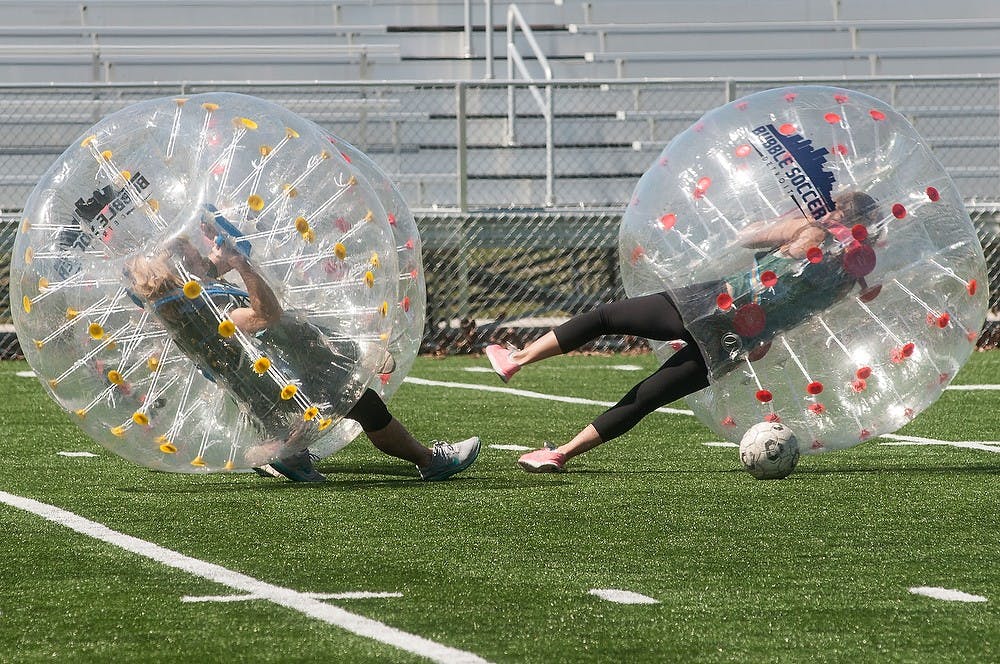 <p>Members of Kappa Kappa Gamma and Sigma Kappa sororities play bubble soccer April 11, 2015, at Sigma Pi Bubble Bash at Munn Field. Fourteen teams competed in the event and some of the sororities and fraternities were represented by two teams. Allyson Telgenhof/The State News.</p>
