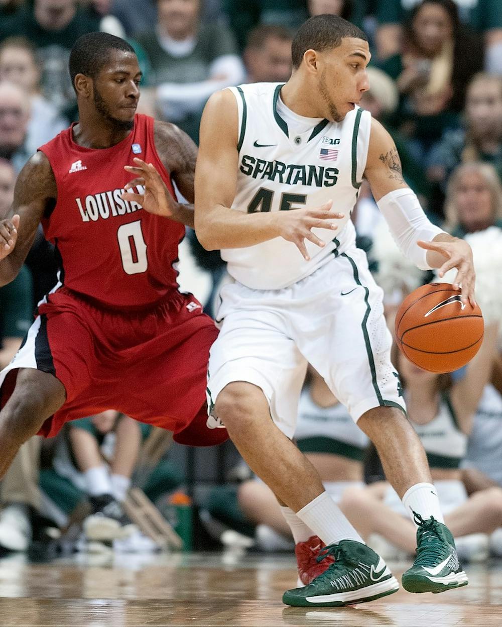 	<p>Freshman guard Denzel Valentine dribbles the ball during the game against Louisiana-Lafayette on Nov. 25, 2012, at Breslin Center. The Spartans beat the Ragin&#8217; Cajuns 60-63. Natalie Kolb/The State News</p>