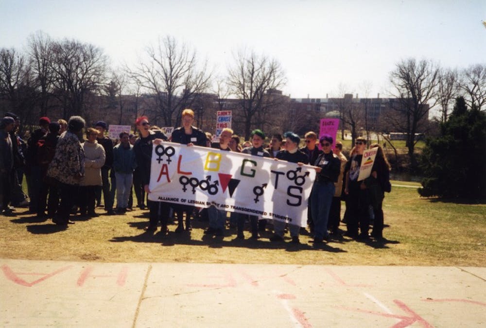Supporters of the Alliance of Lesbian, Bisexual, Gay, Transgendered and Straight Ally Students hold a banner with the letters "ALBGTS" during a Pride Week event, circa 1995.
Photo courtesy of Michigan State University Archives & Historical Collections.