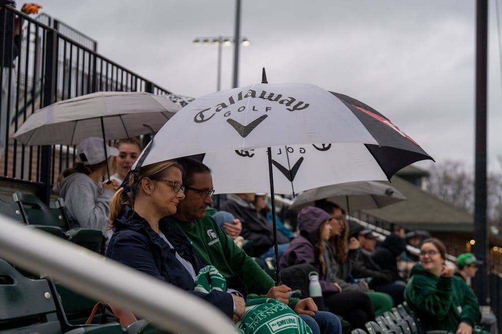<p>Spartan fans stick with their team even in the rain during the MSU baseball game against Western Michigan. MSU lost 18-7 on April 13, 2022.</p>