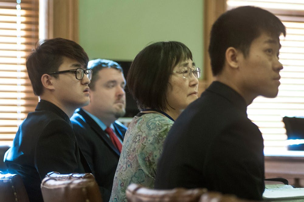 <p>MSU alumnus Meng Long Li and mathematics junior Shan Gao wait to testify Jan. 30, 2015, at 55th District Court in the Ingham County Courthouse, 315 S. Jefferson St., Mason, Michigan. Both men are are being cross-examined about an attack that was made on another Chinese student which occurred Jan. 31, 2014, at Limit Pool & Karaoke Club, 1800 E. Grand River Ave. Allyson Telgenhof/The State News.</p>