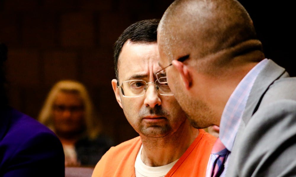 Larry Nassar looks at his defense attorney Matt Newburg during the final day of the preliminary examination hearing in the 55th District Court on June 23.