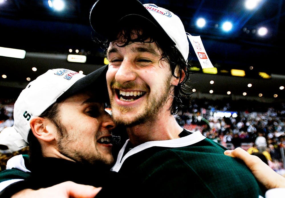 <p>The-junior left defender Ethan Graham, right, embraces then-third-string goaltender Steve Mnich after the Spartans clinched the CCHA Championship and brought the Mason Cup back to East Lansing on March 20, 2006, at Joe Louis Arena. State News File Photo</p>