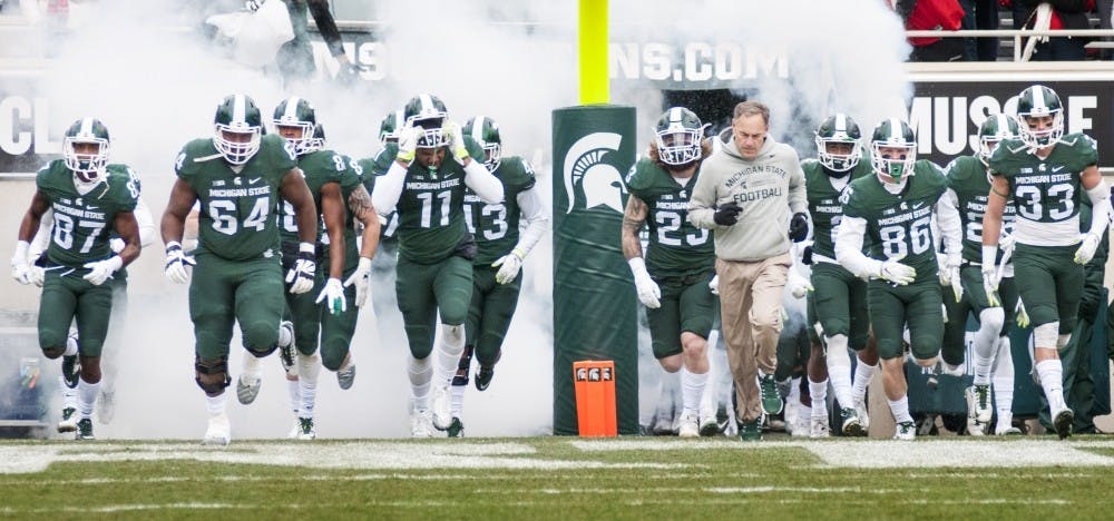 <p>The MSU football team runs out onto the field before the game begins against Ohio State on Nov. 19, 2016 at Spartan Stadium. The Spartans were defeated by the Buckeyes, 17-16.</p>