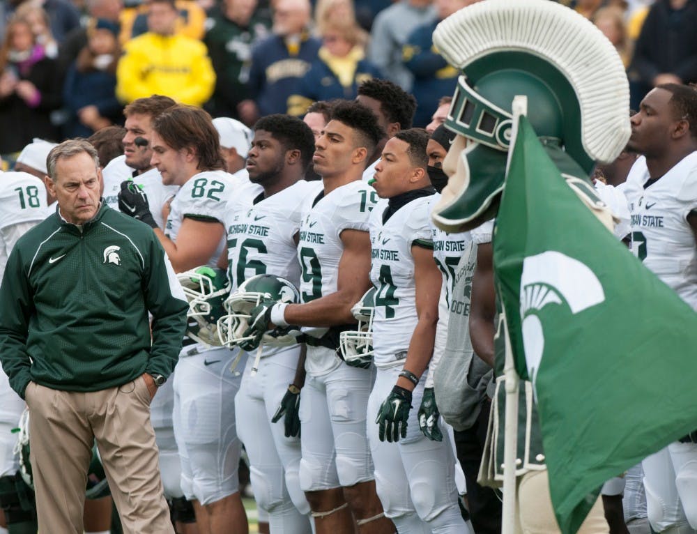 <p>MSU coach Mark Dantonio and the football team line up before the game against Michigan on Oct. 17, 2015 at Michigan Stadium. The Spartans defeated the Wolverines, 27-23.</p>