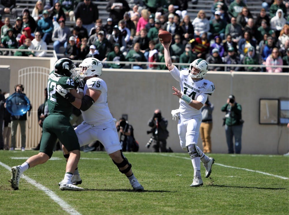 Senior quarter back Brian Lewerke (14) making a pass during the Green and White game at Spartan Stadium on April 13, 2019. The green team defeated the white team 42-26.