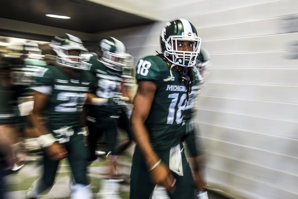 Junior wide receiver Felton Davis III (18) leads the MSU football team as they leave locker room before the game against Notre Dame on Sept. 23, 2017 at Spartan Stadium. The Spartans fell to the Fighting Irish, 38-18. 