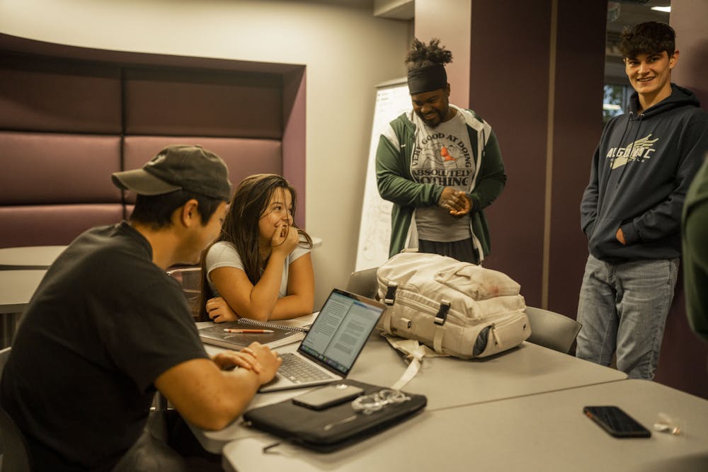 Residential Assistant Marvin Pride talks to people on their floor in Bailey Hall on Oct. 19, 2022. 