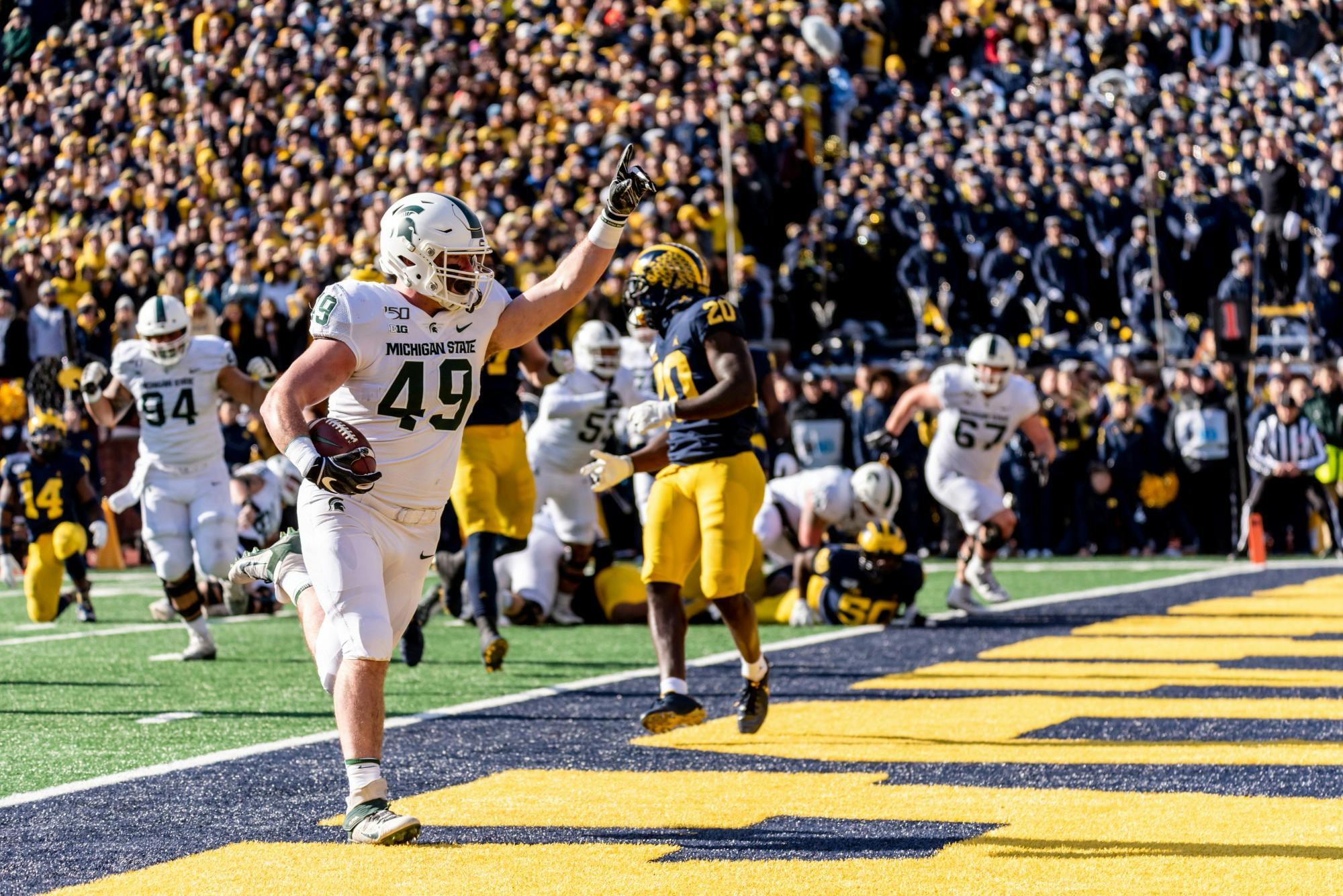 Sophomore fullback Max Rosenthal (49) scores a touchdown against Michigan. The Spartans fell to the Wolverines, 44-10, at Michigan Stadium on November 16, 2019. 