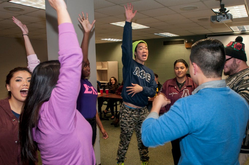 <p>Hospitality business senior Dong Jun Lee and other members of the Multicultural Greek Council e-board play trivia together on Nov. 12, 2014, at the Student Services Building. Lee's organization Lambda Phi Epsilon and other greek organizations all came together for a game night event. Raymond Williams/The State News</p>