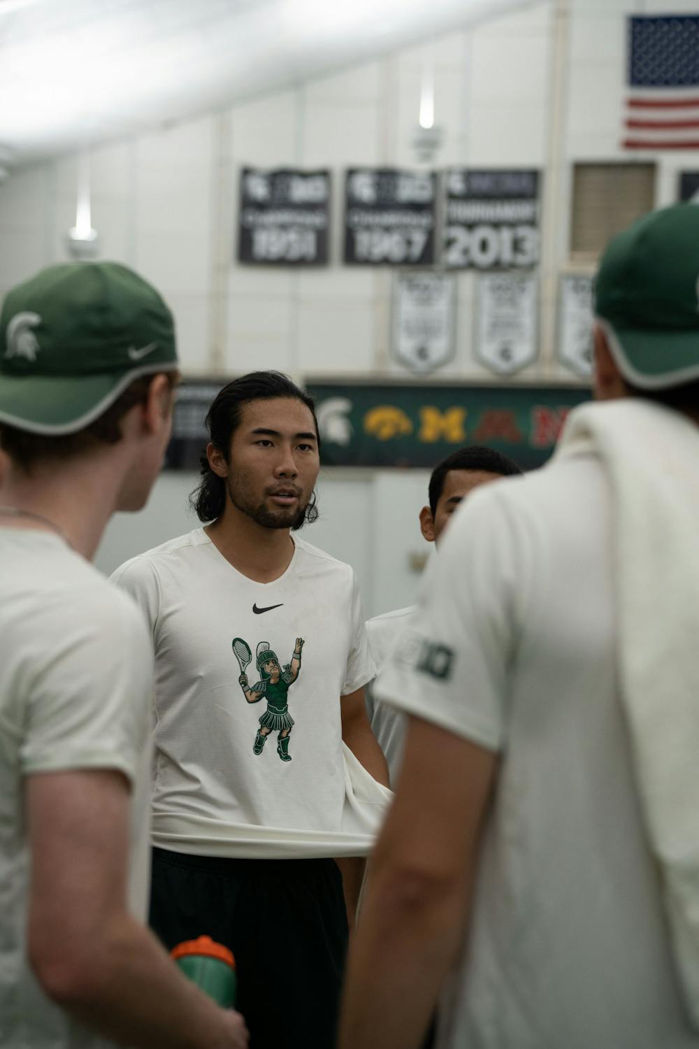 <p>Senior Kazuki Matsuno encourages the men's tennis team ahead of their singles matches against Michigan at the MSU Tennis Center on March 30, 2023. The Spartans lost to the Wolverines 6-1.</p>