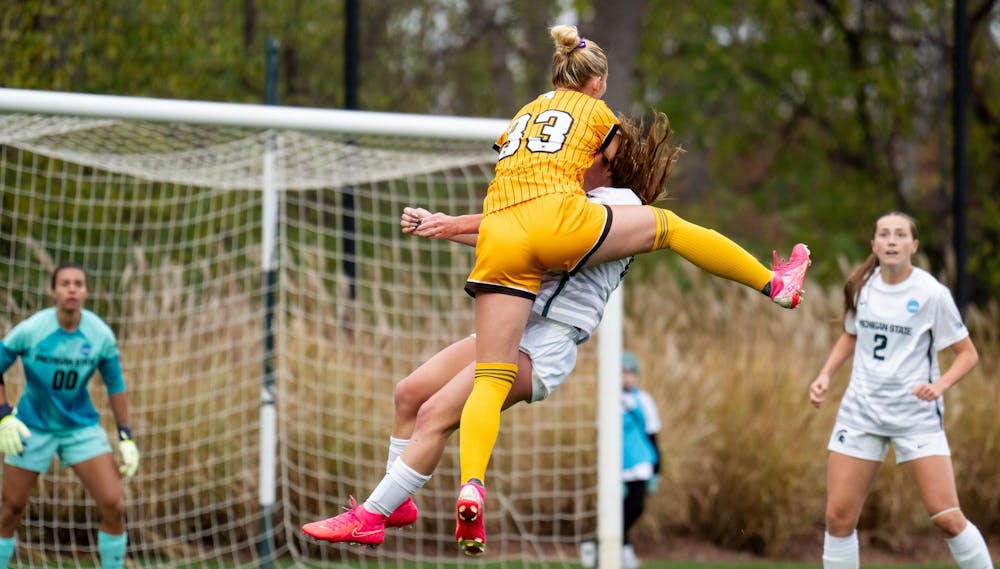 <p>Western Michigan University graduate forward Callie Cunningham (33) and Michigan State University freshman midfielder Kaleigh McPherson (16) fight for the ball during the NCAA soccer tournament game between MSU and WMU on Nov. 16, 2024. The Spartans defeated the Broncos, 3-1.</p>