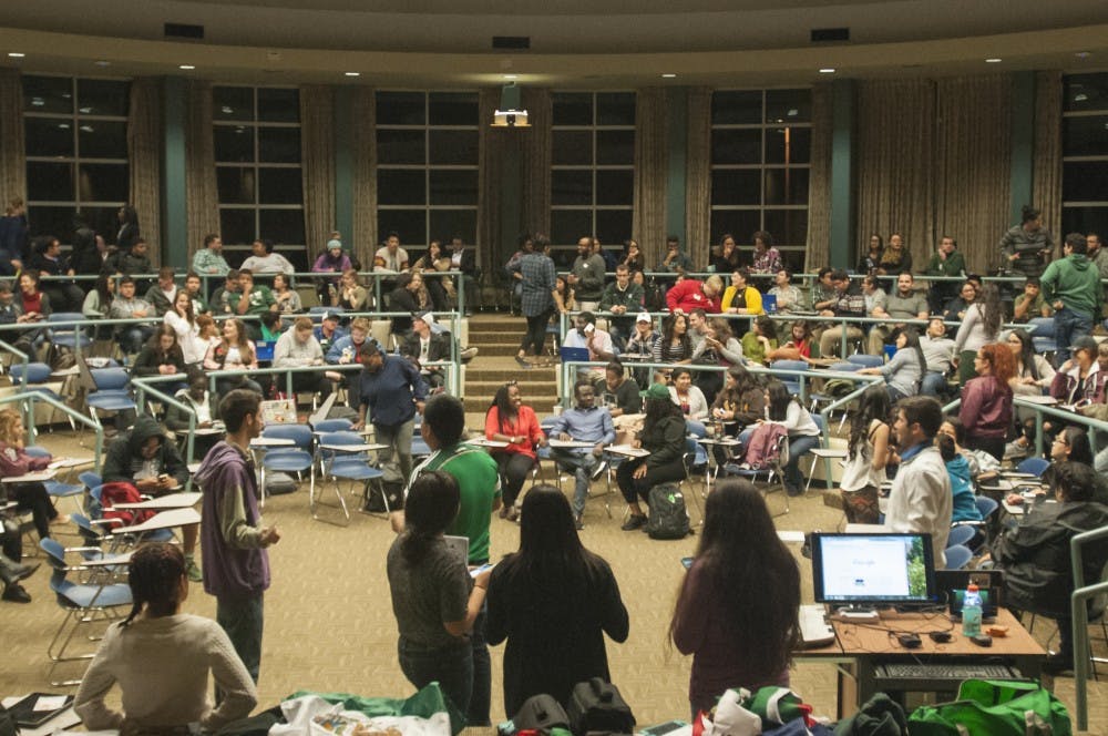 People sit and talk before the Latinx Students In Need of Solidarity Town-Hall on Oct. 13, 2016 in the Erickson Hall Kiva. The town-hall, hosted by Culturas de las Razas Unidas, included emotional stories from students who had experienced racism.