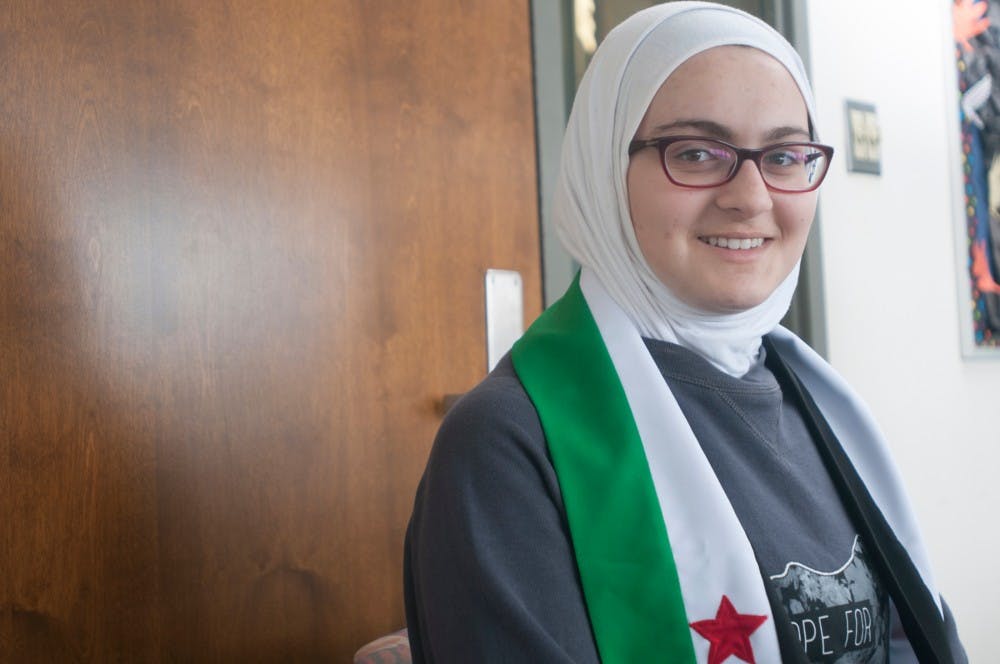 Physiology junior Tasneem Sannah posed for a photo on March 1, 2016 at East Holmes Hall. Sannah was wearing a Syrian flag  and sweatshirt. 