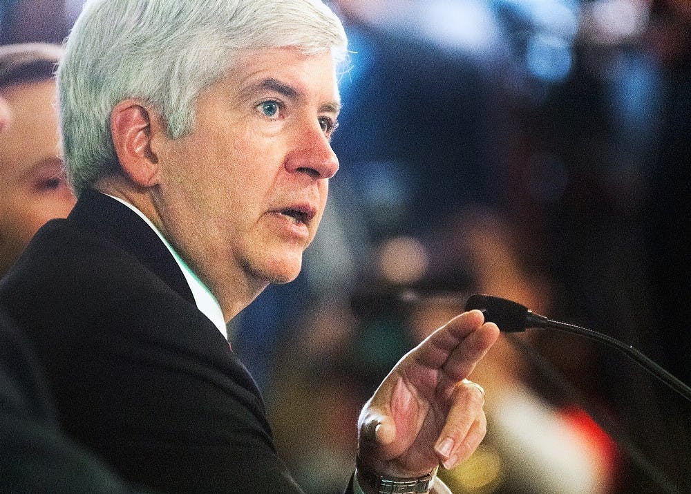 <p>Then-Gov. Rick Snyder unveils his recommendations for Michigan’s budget for the 2014 fiscal year. Before the budget proposal can be implemented, the Michigan House and Senate both must pass it. Adam Toolin/The State News</p>