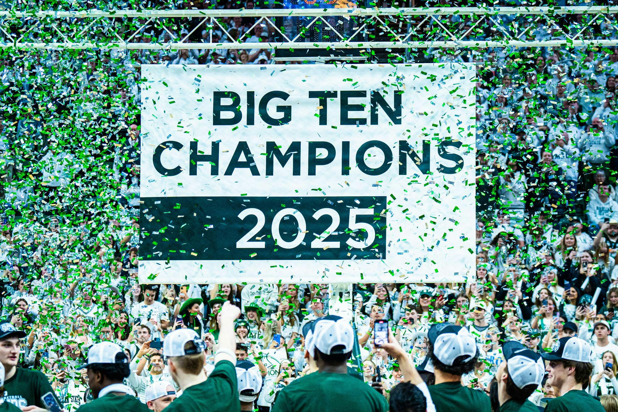 <p>Members of the Michigan State men's basketball team celebrate as their 2025 Big Ten Champions banner is unveiled at the Breslin Center on March 9, 2025.</p>