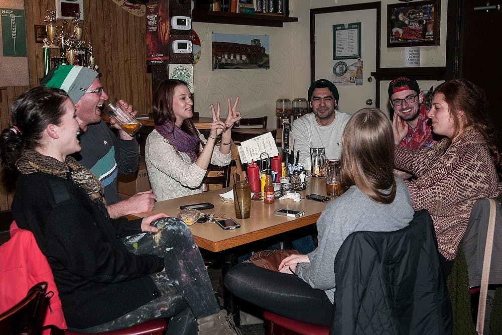 <p>Ann Arbor resident Rosemarie Royce tells her friend, alumna Natassa Christides, how to pose for a photo Feb. 24, 2015, at the Peanut Barrel, 521 E. Grand River Ave. The group was celebrating Christides' 22nd birthday over drinks. Allyson Telgenhof/The State news.</p>