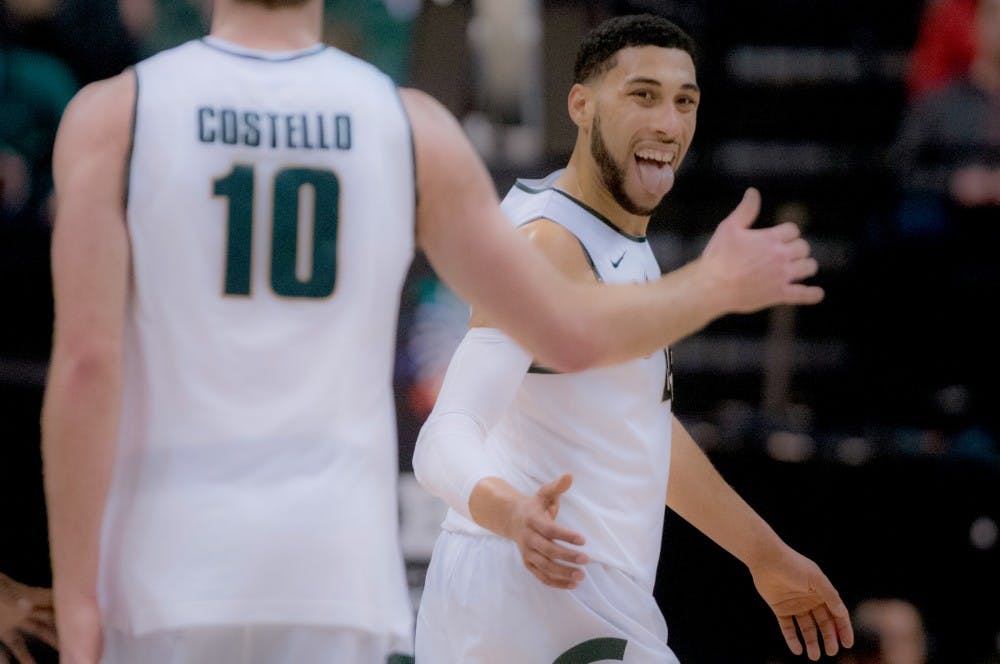 Senior forward Matt Costello high fives senior guard Denzel Valentine during the second half of the game on March 11, 2016 at Bankers Life Fieldhouse in Indianapolis, Indiana. The Spartans defeated the Buckeyes 81-54. 